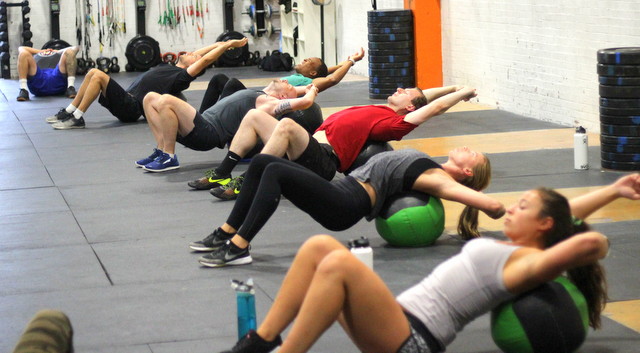 using a medicine ball to loosen our backs